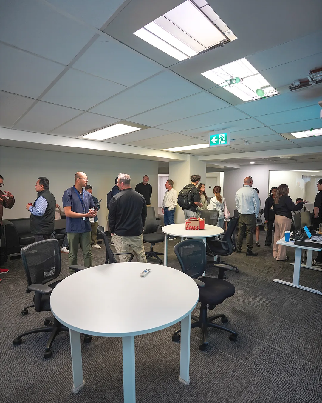 Participants talking in small groups at Alebex&rsquo;s first Vancouver hackathon meetup.