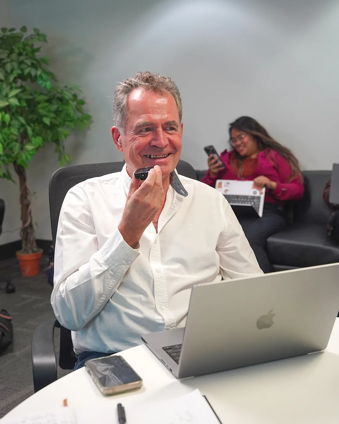 A participant smiling at his laptop during the event.